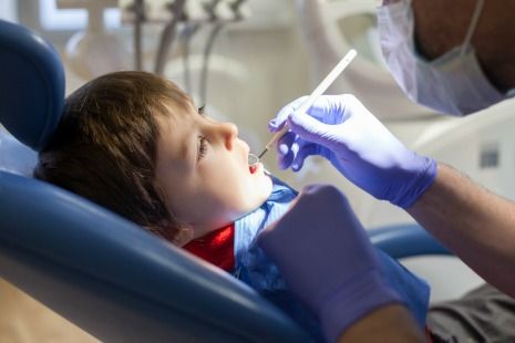 Dentist checking kids teeth