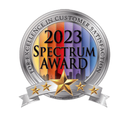 A 2023 "spectrum award for excellence in customer satisfaction" badge featuring colorful city skyline graphics and a gold star.